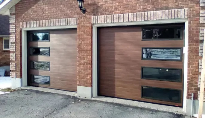 Two spacious garage doors with side windows, providing natural light and visibility.